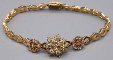 Yellow metal diamond cluster bracelet, the central floral cluster set with eight brilliant cut