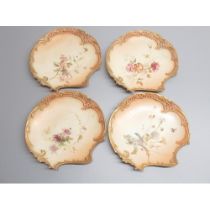 Nine Royal Worcester scallop shaped dessert plates, painted with flowers butterflies and other