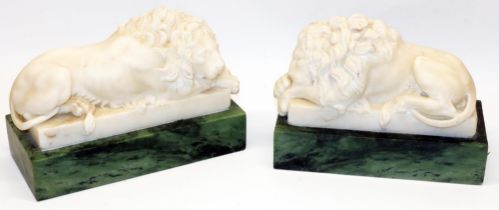 Pair of Grand Tour style white marble models of recumbent lions, on green marble rectangular