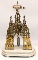 Victorian brass Cathedral style skeleton clock on stepped white marble base, the pierced frame of