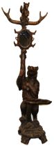 C19th carved Bear Black Forest hall stand, the parent Bear supporting a trunk with oval mirror,