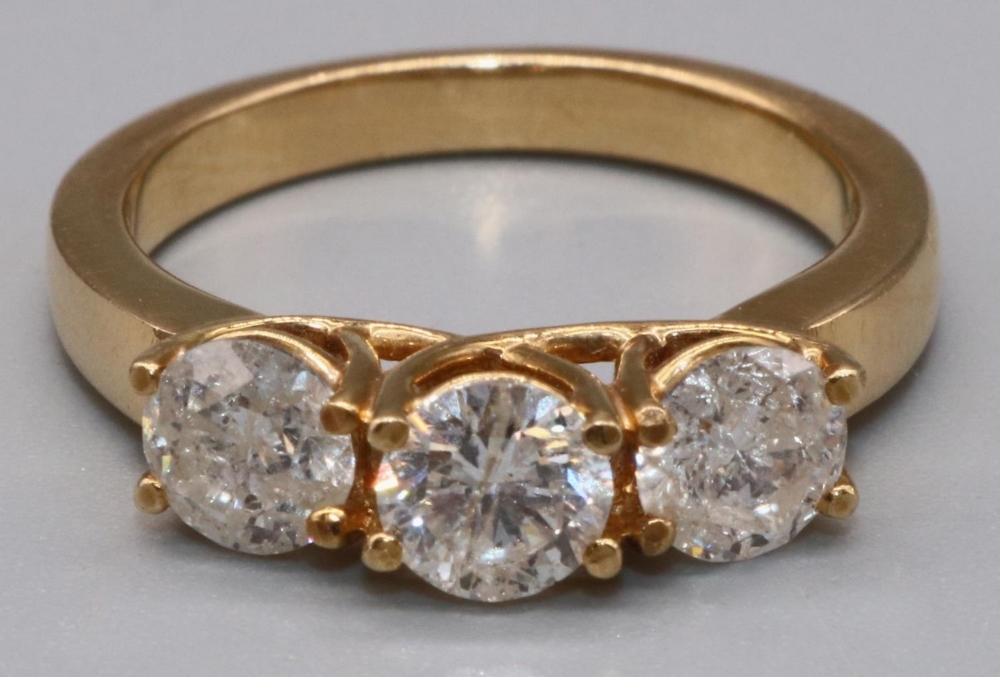 18ct yellow gold three stone diamond ring, the three brilliant cut diamonds in claw settings on