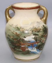 Early 20th century Japanese Satsuma twin handled vase, decorated a landscape, signed in panel on