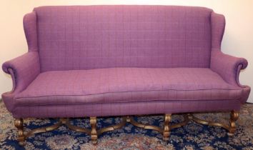 Queen Anne style sofa, with high wing back and outsplayed arms, on gilt angular S-scroll supports