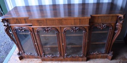 Victorian rosewood break front side cabinet, with frieze drawer above four scroll moulded glazed