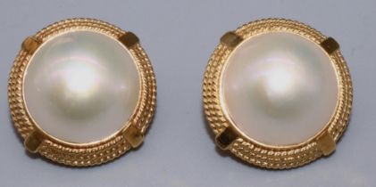 Pair of 18ct yellow gold Mabe pearl set earrings with rope twist surrounds on clip backs, stamped