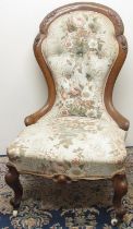 Victorian walnut framed nursing chair, upholstered back and serpentine seat on cabriole legs with