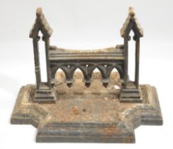 Large Victorian cast iron boot scraper, with arcade frieze and pierced tower supports, on stepped