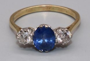 18ct yellow gold sapphire and diamond three stone ring, the central oval cut sapphire flanked by two