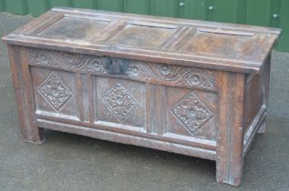 C17th carved oak coffer, hinged three panel lid above scroll and rosette frieze and three lozenge