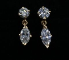 yellow metal diamond drop earrings, set with single round cut diamond above a marquise cut