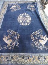 Blue ground Chinese carpet, with central stylized floral medallion in similar repeating border,