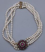 Four row pearl necklace with 9ct yellow gold clasp stamped 375, and central yellow and white metal