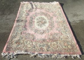 Salmon pink ground Chinese rug, oval wreath medallion centre in scroll border, 280cm x 180cm