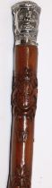 Victorian carved walking cane with unmarked Indian white metal grip, the shaft relief carved with