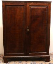 Early C19th oak Housekeepers cupboard, with moulded top above two fielded panel doors revealing