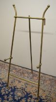 Arts and Crafts design brass picture easel, tubular frame with adjustable height and reeded ball