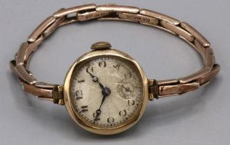 Swiss ladies gold wristwatch, silvered engine turned Arabic dial with subsidiary seconds, two