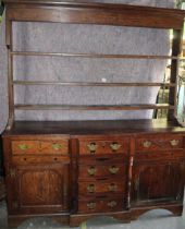 George 1V oak breakfront dresser, later three tier rack, with moulded cornice, the base with six