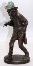 M. Faehnrich (C20th) "Wandering Violinist" patinated bronze model of a striding man in a hat and