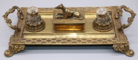 Victorian brass rectangular inkstand with gothic cast border and scroll handles, two glass wells and
