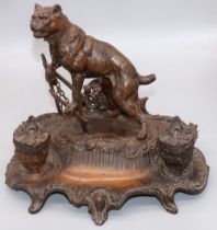 After A. Bossu (French C20th); Patinated spelter inkstand, with two urn shaped wells and a mastiff