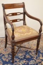 Regency mahogany elbow chair, with curved cresting rail, two pierced splats and drop-in woolwork