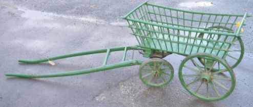 Early C20th green painted wooden Dog cart, spindle turned body with metal bound spoked wheels,