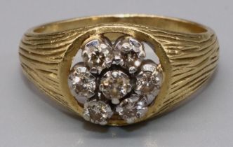 18ct yellow gold diamond cluster ring, the seven brilliant cut diamonds on signet style textured