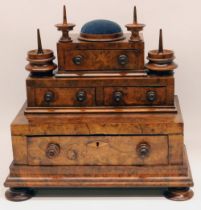 Victorian figured walnut stepped sewing cabinet, one long and three short drawers with turned wooden