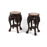 Property of a deceased estate - a pair of Chinese carved hardwood stands with pink marble inset