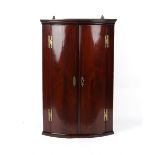 Property of a lady - a mid 18th century George II/III mahogany bow-fronted two-door corner wall
