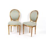 Property of a lady - a pair of early 20th century French Louis XVI style giltwood side chairs (2).