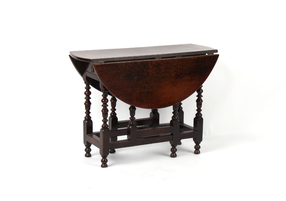 Property of a gentleman - a small William & Mary oak oval topped gate-leg table, circa 1670/80, of