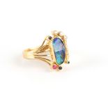 A modern 18ct yellow gold black opal ruby emerald sapphire & diamond ring, size T/U.