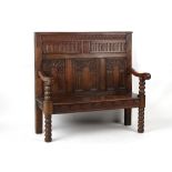 Property of a deceased estate - a carved oak & beechwood settle, elements 17th century, 50.4ins. (