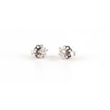 A pair of 18ct white gold diamond stud earrings, the princess cut diamonds weighing approximately