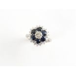 An 18ct white gold sapphire & diamond cluster ring, the six round cut sapphires weighing a total