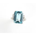 A good Art Deco style aquamarine & diamond ring, the vibrant blue octagonal cut aquamarine