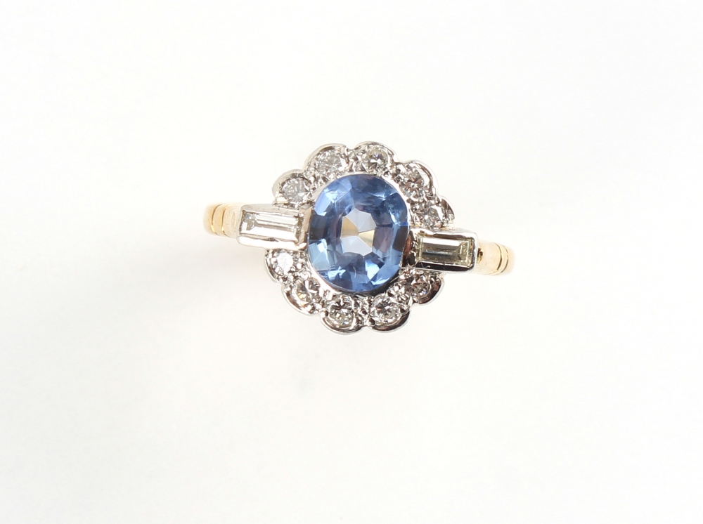 An 18ct yellow gold sapphire & diamond cluster ring, the round cut sapphire weighing an estimated - Image 2 of 2