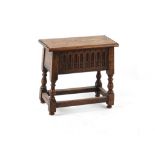 A 17th century style carved oak box stool, 20ins. (50.8cms.) wide (overall).
