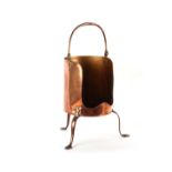 Property of a gentleman - a George III copper plate warmer, on three legs, with swing handle.