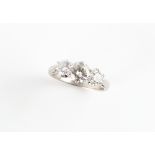 An 18ct white gold diamond three stone ring, the centre round brilliant cut diamond weighing an