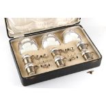 Property of a gentleman - a cased set of six Aynsley coffee cups & saucers with silver cup holders &