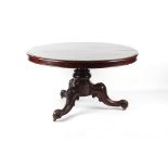 Property of a lady - a Victorian mahogany circular tilt-top dining table, with carved tripod base,
