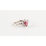 An 18ct white gold ruby & diamond oval cluster ring, size L.