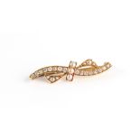 A late 19th / early 20th century unmarked gold diamond & pearl ribbon brooch, 38mm long excluding