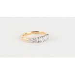 An 18ct yellow gold diamond five stone ring, the round brilliant cut diamonds weighing an