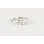 A good platinum oval brilliant cut diamond three stone ring, the GIA certificated stones weighing