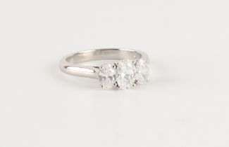 A good platinum oval brilliant cut diamond three stone ring, the GIA certificated stones weighing